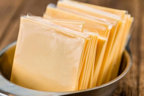 Sliced Cheese on a vintage background as detailed close-up shot (selective focus)