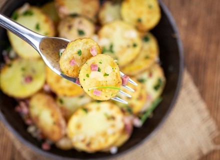 Portion of fresh homemade Fried Potatoes on an old wooden table (selective focus, close-up)