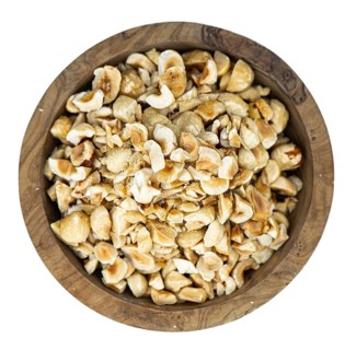 Freshly chopped Hazelnuts as detailed close up shot isolated on white background (selective focus)