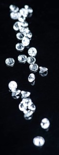 Small Diamonds on dark background as close up shot (selective focus)