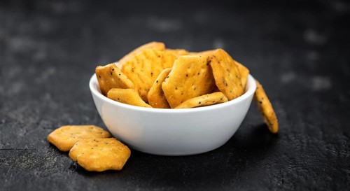 Portion of mixed Snacks on dark background (detailed close up shot, selective focus)
