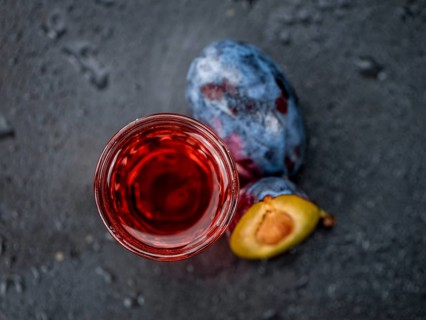 Some Plum Liqueur on a vintage slate slab, selective focus