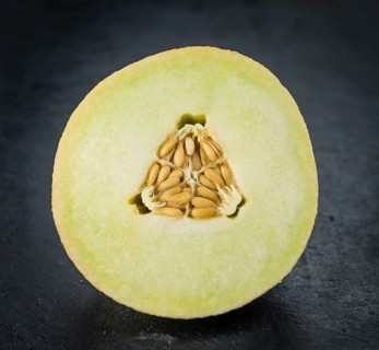 Honeydew Melon on a vintage background as detailed close-up shot (selective focus)