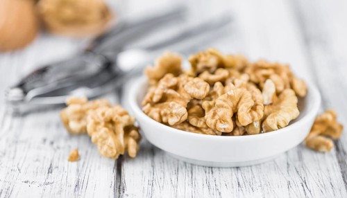 Walnut kernels on a vintage background as detailed close-up shot (selective focus)
