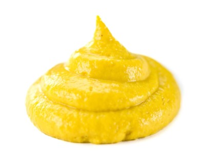 Portion of Mustard (as close-up shot) isolated on white background