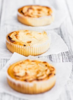 Homemade Cheesecake on an wooden table (selective focus) as detailed close-up shot