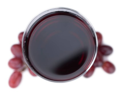 Red Grape Juice isolated on white background (selective focus, close-up shot)