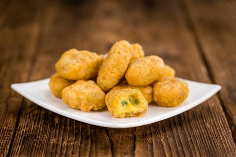 Chili Cheese Nuggets on a vintage background as detailed close-up shot (selective focus)