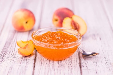 Peach Jam on a vintage background as detailed close-up shot, selective focus