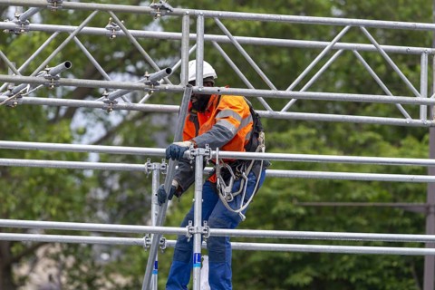 Scaffolders at work, erecting a large scaffold, grandstands for the Olympic Games, Place de la