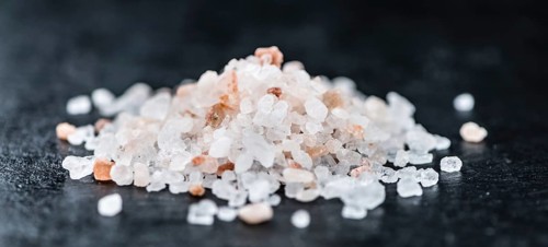 Pink Salt on a vintage background as detailed close-up shot (selective focus)