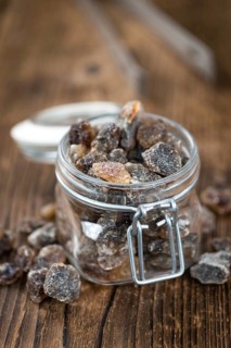 Brown Rock Candy on wooden background (selective focus, close-up shot)