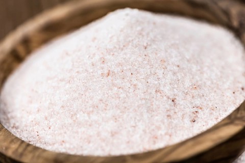 Pink Himalayan Salt on an old wooden table as detailed close-up shot (selective focus)