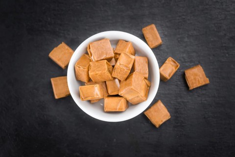 Caramel on a vintage background as detailed close-up shot (selective focus)