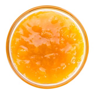 Apricot Jam isolated on white background (selective focus, close-up shot)