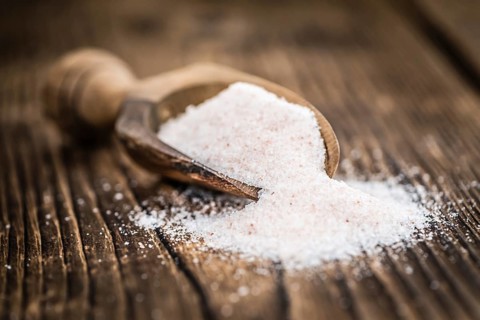 Pink Himalayan Salt on rustic wooden background (close-up shot)