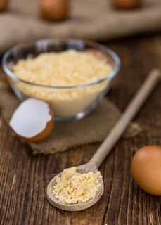Vintage wooden table with Powdered Eggs (selective focus, close-up shot)
