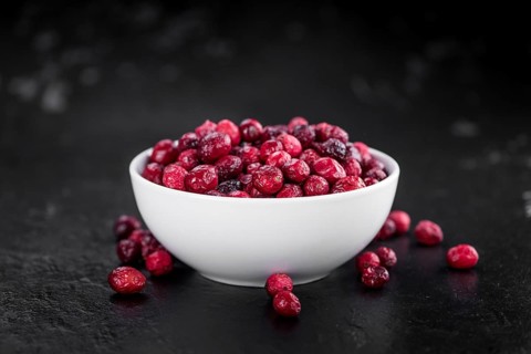 Portion of healthy Dried Cranberries on a slate slab (selective focus)