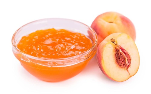 Portion of Peach Jam on a rustic slate slab, selective focus, close-up shot