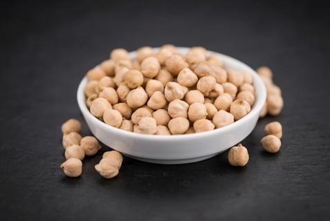 Portion of dried Chickpeas on a rustic slate slab, selective focus, close-up shot