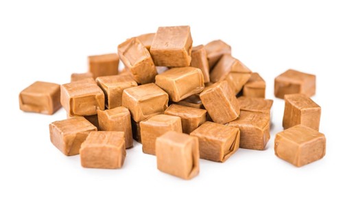 Portion of Caramel (as close-up shot) isolated on white background