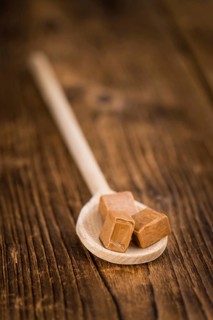 Caramel on a vintage background as detailed close-up shot (selective focus)
