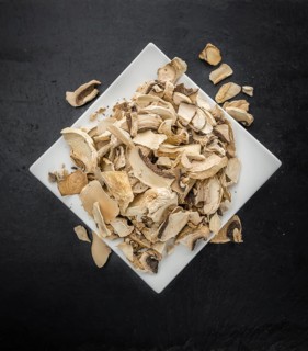 Dried white Mushrooms on a vintage background as detailed close-up shot, selective focus