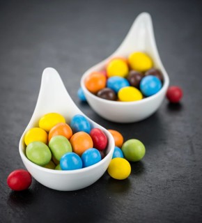 Portion of Cocolate coated Peanuts as detailed close up shot on a slate slab (selective focus)