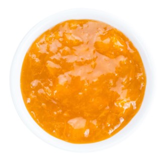 Apricot Jam isolated on white background (selective focus, close-up shot)