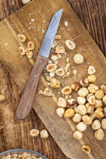 Freshly chopped Hazelnuts as detailed close up shot (selective focus)