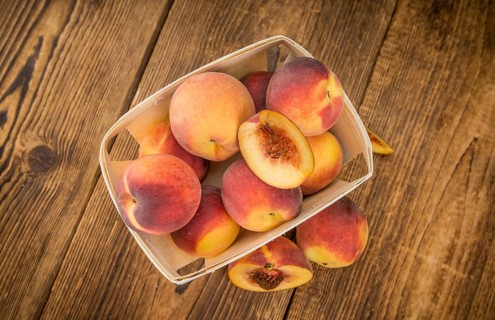 Portion of fresh Peaches close-up shot, selective focus