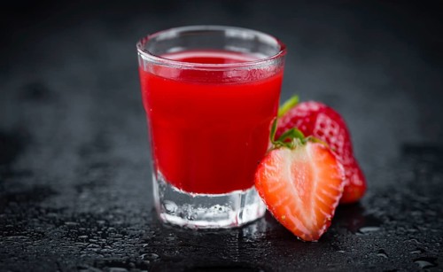 Some homemade Strawberry liqueur as detailed close-up shot, selective focus