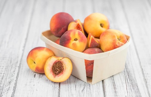 Peaches on a vintage background as detailed close-up shot, selective focus
