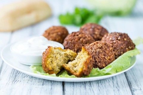 Wooden table with Falafels (close-up shot, selective focus)
