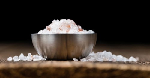 Pink Salt on a vintage background as detailed close-up shot (selective focus)