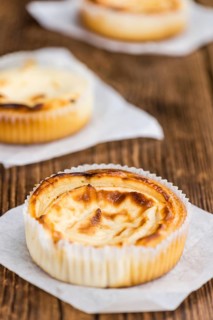 Fresh made Mini Cheesecake on an old and rustic wooden table (selective focus, close-up shot)