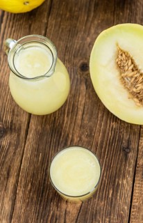 Healthy Honeydew Melon Smoothie (selective focus) on an old wooden table