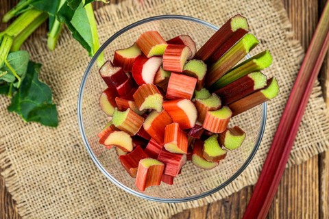 Chopped Rhubarb on an old wooden table (close up shot, selective focus)