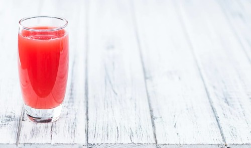 Homemade Watermelon Smoothie on an wooden table (selective focus) as detailed close-up shot