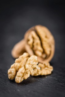 Walnut kernels on a vintage background as detailed close-up shot (selective focus)