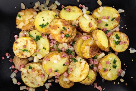 Portion of fresh homemade Fried Potatoes on an old wooden table (selective focus, close-up)