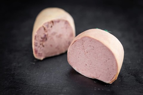 Liverwurst on a vintage background as detailed close-up shot (selective focus)