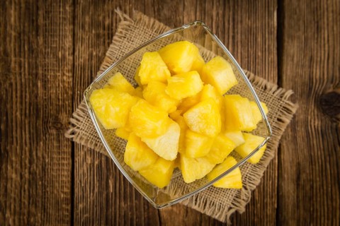Fresh made Pineapple (sliced) on a vintage background as detailed close-up shot
