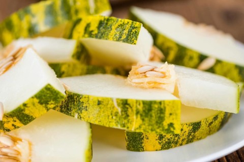Portion of fresh Futuro Melons (close-up shot, selective focus)