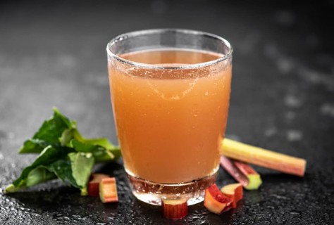 Rhubarb Juice on a rustic background (close up shot, selective focus)