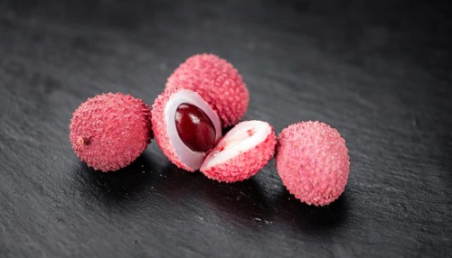 Lychees on a vintage background as detailed close-up shot (selective focus)