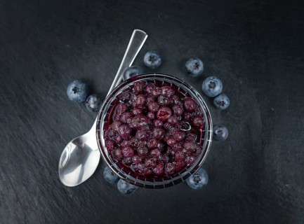 Canned Blueberries on a vintage slate slab as detailed close-up shot, selective focus