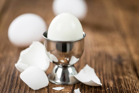 Wooden table with boiled Eggs (selective focus, close-up shot)