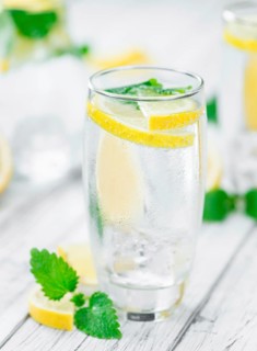 Homemade Lemonade on vintage background (selective focus, close-up shot)