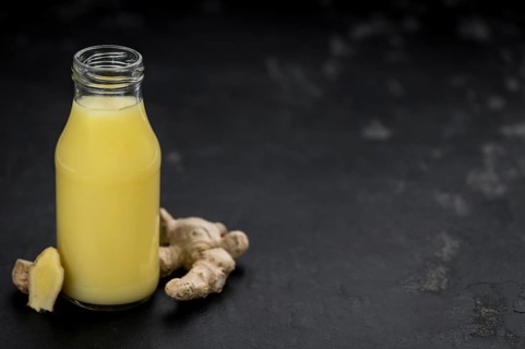 Portion of healthy Ginger Drink (selective focus, close-up shot)
